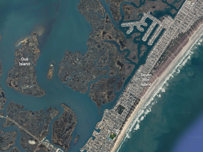 Aerial satellite view of Seven Mile Island and Gull Island, showing the developed barrier island along the Atlantic shoreline, Gull Island to the west, and surrounding marsh islands and waterways.